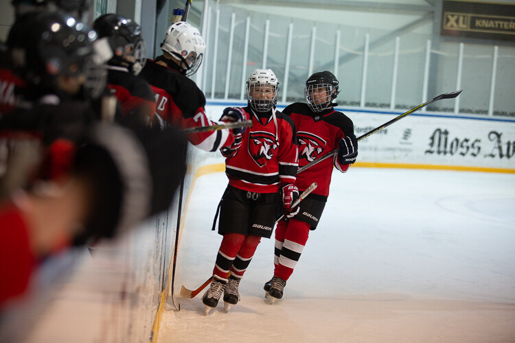 An ice hockey image that is nearly ruined by poor lighting and color casts - Tips for Editing Hockey Photos in Lightroom